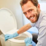 uomo pulisce il WC
